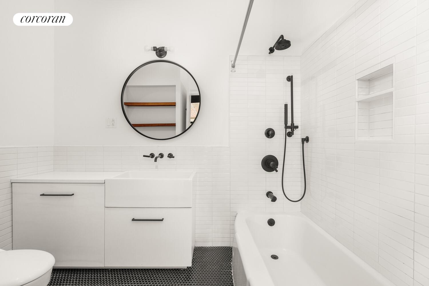 430 East 10th Street, Unit 2B Manhattan, NY 10009 - Photo 8 of 9 a bathroom with a sink a toilet and a mirror