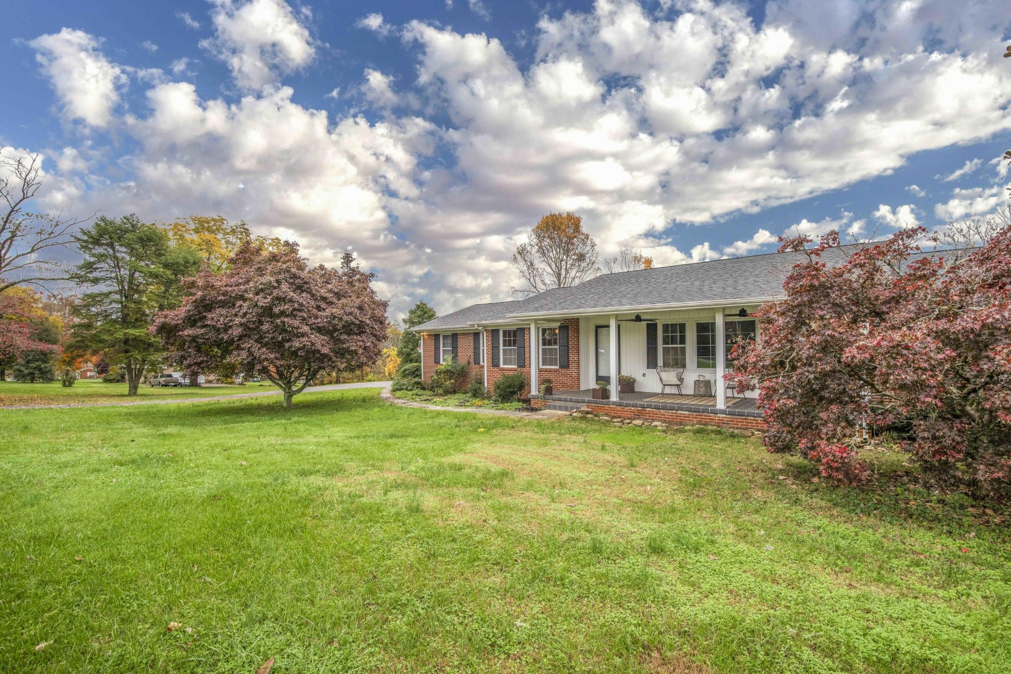 395 Mountain View Road Lenoir City, TN 37771 - Photo 3 of 34 a front view of house with yard and trees in background