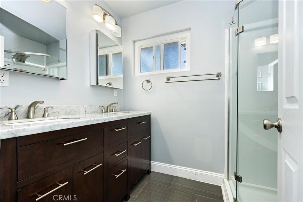 3112 Glenn Road Oceanside, CA 92056 - Photo 18 of 30 a bathroom with a double vanity sink a and mirror