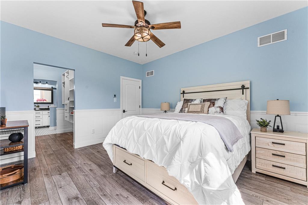 2460 Chapel Road Beaver, PA 15009 - Photo 17 of 42 a bedroom with a large bed and a chandelier