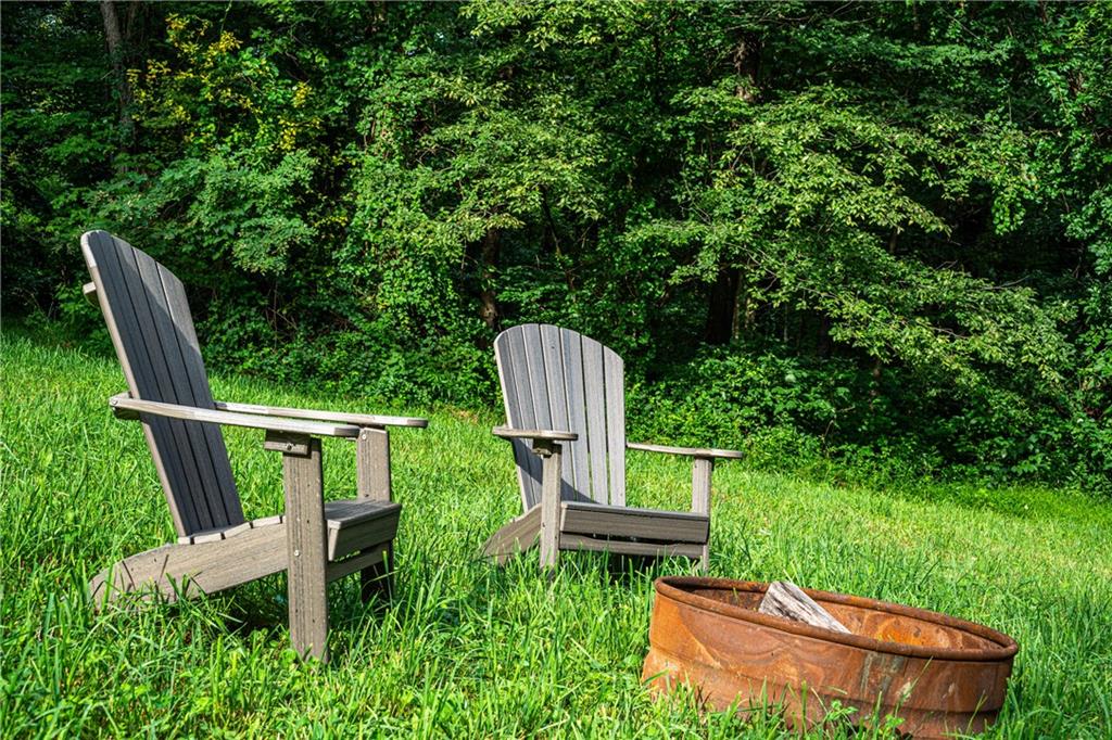 2460 Chapel Road Beaver, PA 15009 - Photo 39 of 42 a backyard of a house with table and chairs wooden fence and a bench