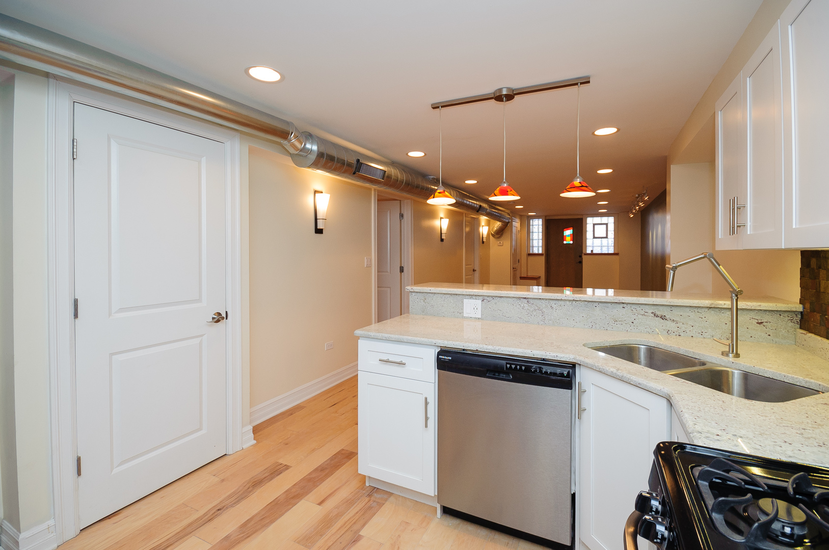 2155 West Potomac Avenue, Unit GDN Chicago, IL 60622 - Photo 3 of 16 a kitchen with a sink appliances and cabinets