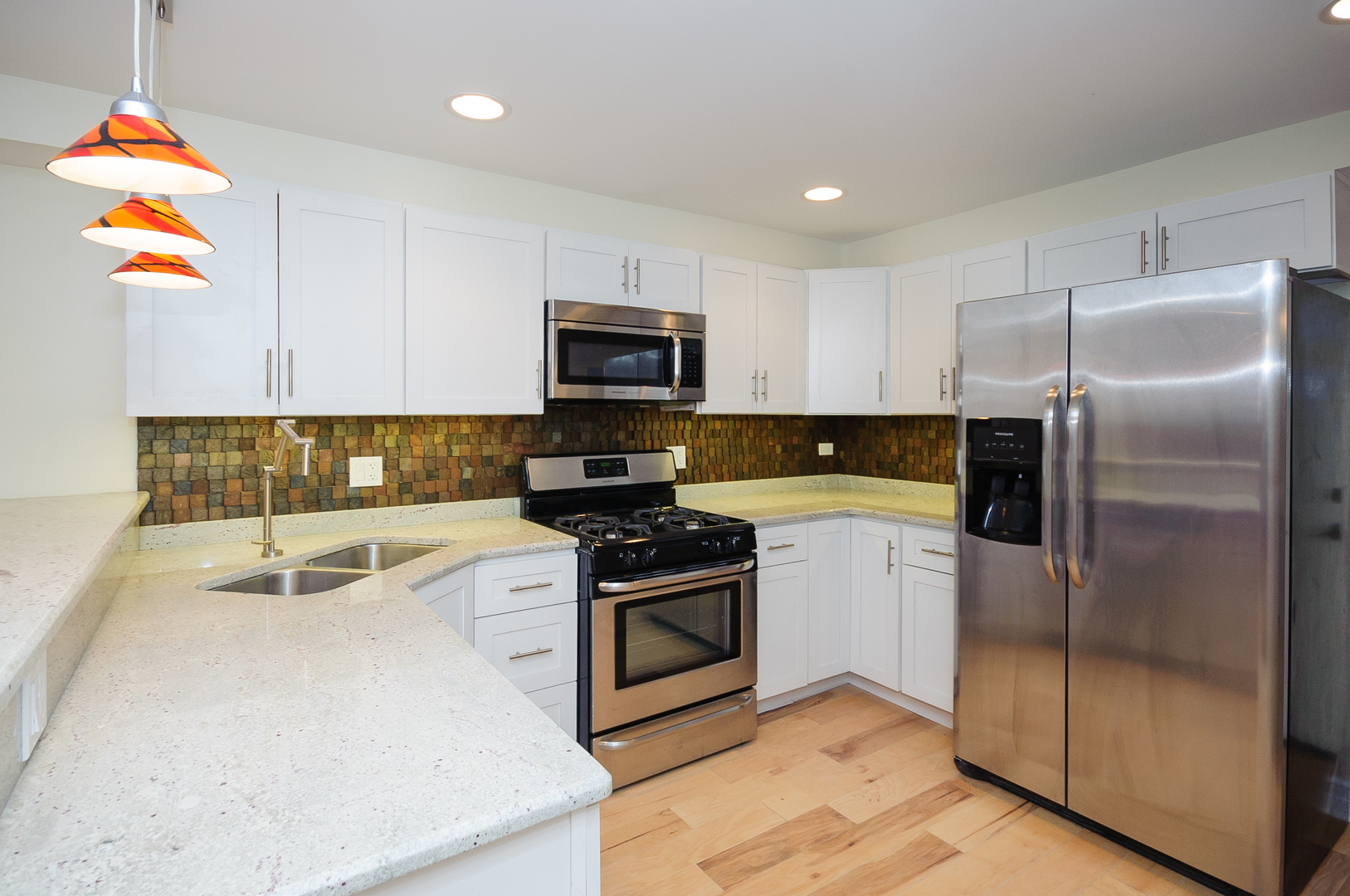 2155 West Potomac Avenue, Unit GDN Chicago, IL 60622 - Photo 4 of 16 a kitchen with a refrigerator a microwave a sink and a stove