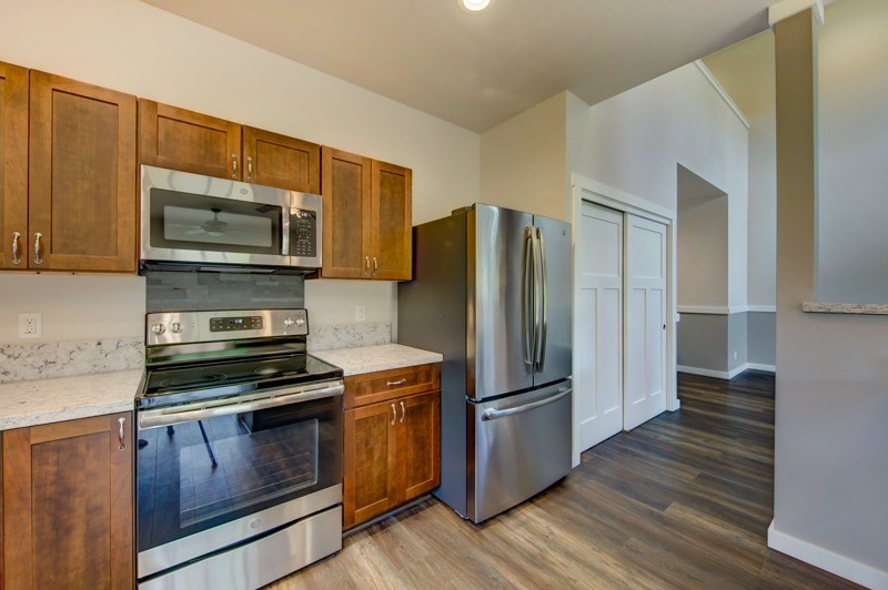 6754 A Pulama Road Kapaa, HI 96746 - Photo 8 of 22 a kitchen with granite countertop wooden cabinets a stainless steel appliances and wooden floor