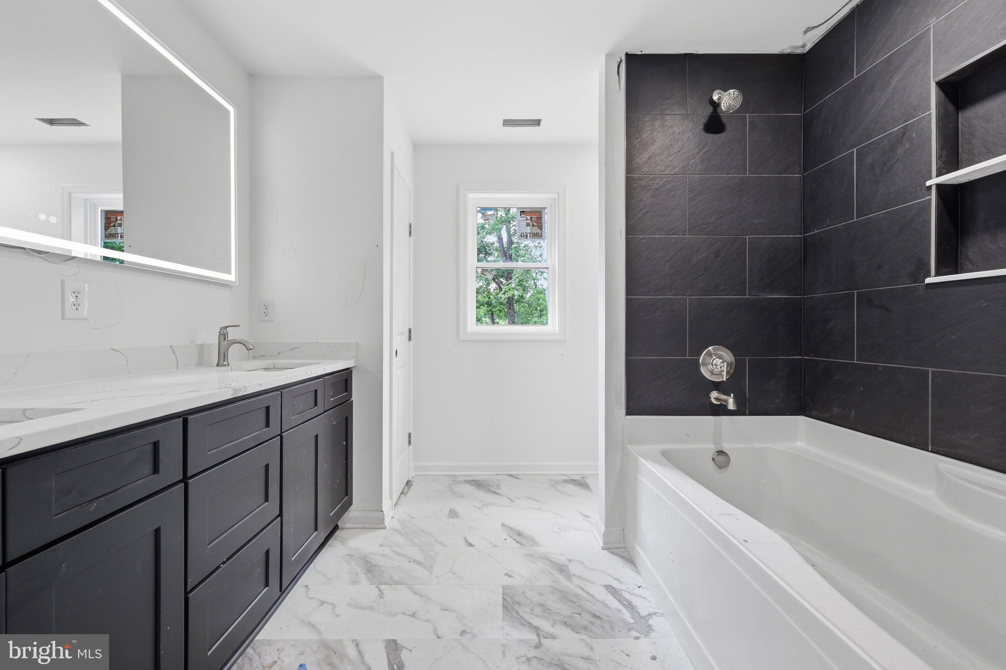 10339 Back Creek Valley Road Hedgesville, WV 25427 - Photo 27 of 48 a bathroom with a tub sink and mirror