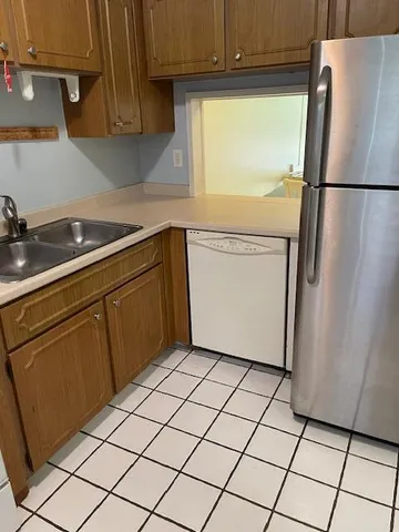 a kitchen with a refrigerator sink and cabinets