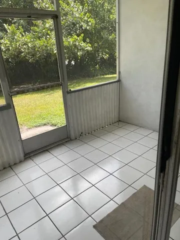 a view of a room with a large window and yard