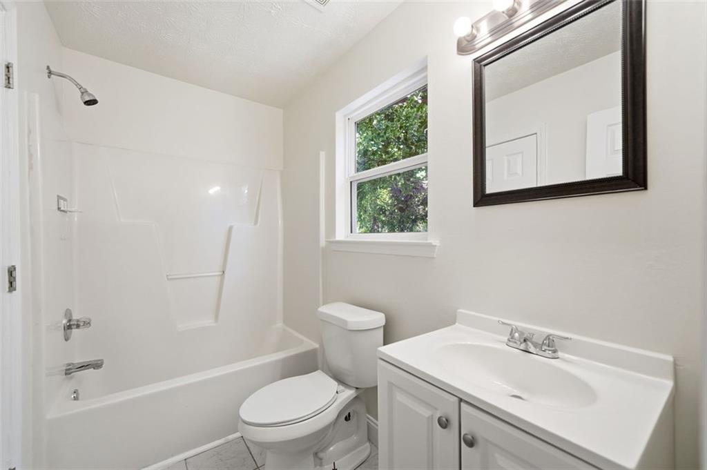 1512 Upper Sassafras Road Jasper, GA 30143 - Photo 28 of 41 a white toilet sitting next to a bathroom sink