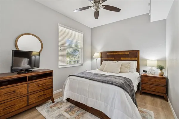 a bedroom with a bed and a television