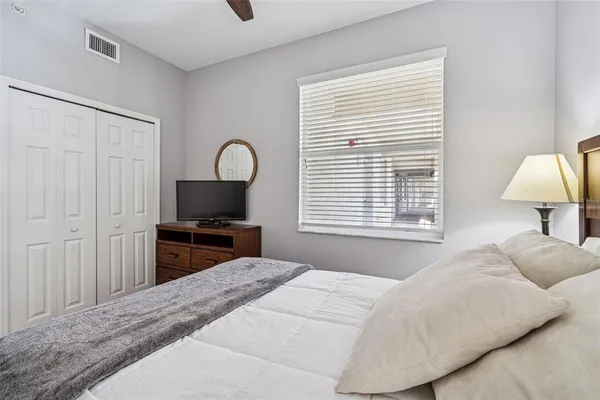 a bedroom with a bed and a lamp