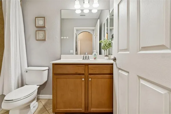 a bathroom with a white toilet sitting next to a bathtub
