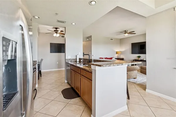 a kitchen with stainless steel appliances granite countertop a stove a sink and a refrigerator