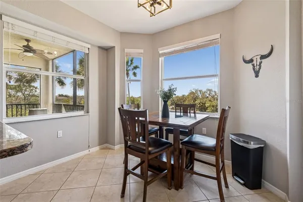 a living room with furniture a flat screen tv and a large window
