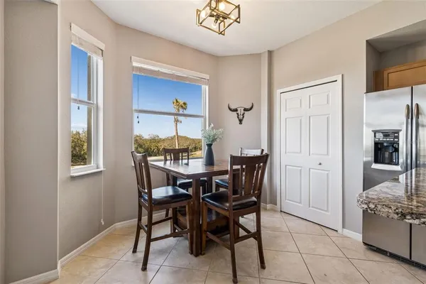 a bedroom with a bed a couch and large window