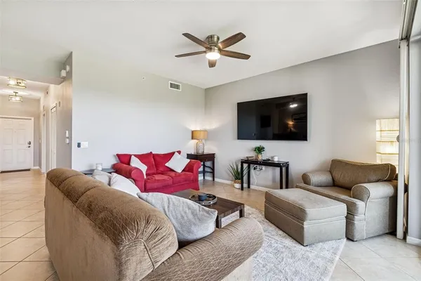 a living room with furniture and a kitchen