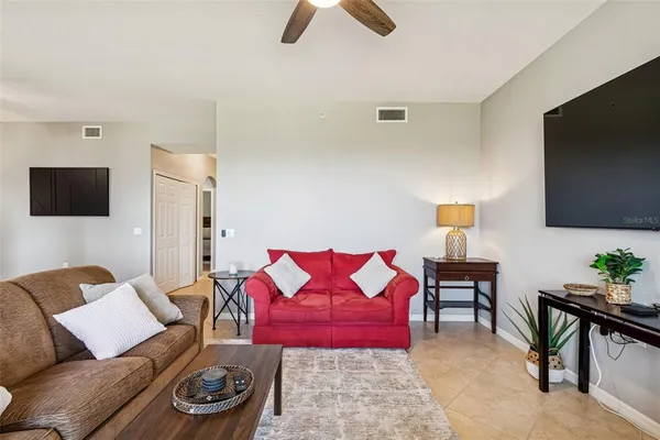 a living room with furniture and a potted plant