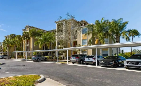 an aerial view of ocean and residential houses with outdoor space