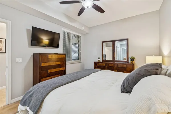 a bedroom with a bed and a potted plant