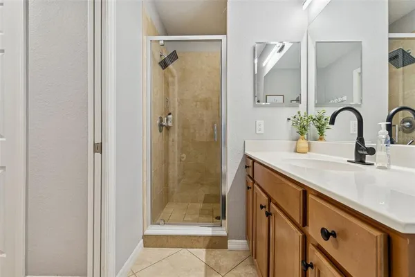 a bathroom with a sink a toilet a shower and a mirror