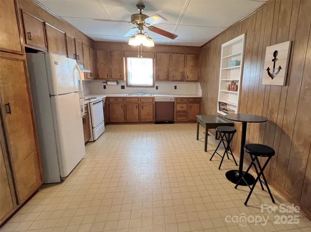 a view of a livingroom with furniture a ceiling fan and window