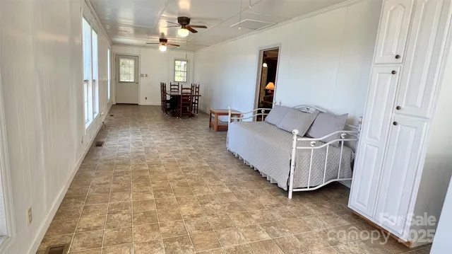 a view of a kitchen with white cabinets and a sink