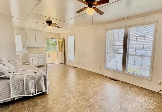 a bedroom with a bed and a lamp on dresser
