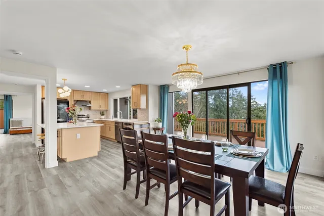 a view of a dining room with furniture large windows and wooden floor
