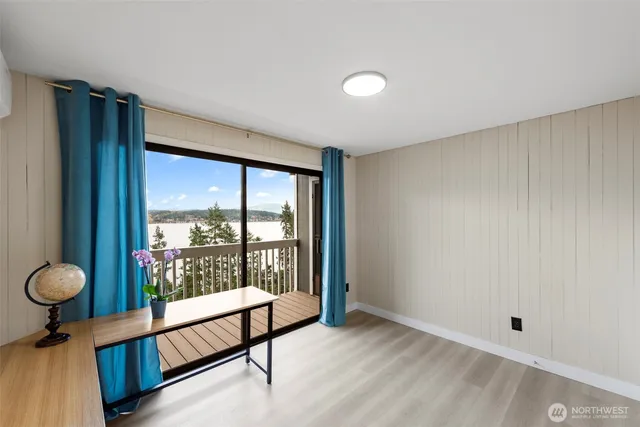 a view of a room with gym equipment and floor to ceiling window