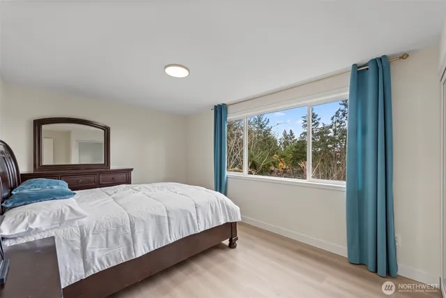 a bedroom with a large bed and a window