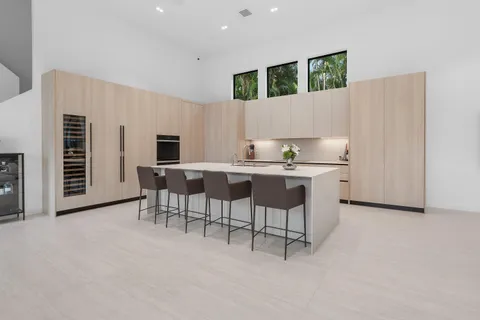 a kitchen with a cabinets and chairs