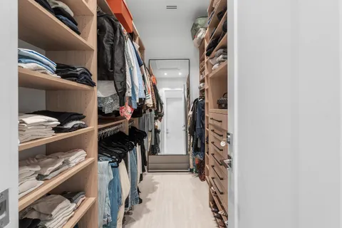 a large bed sitting in a bedroom next to a window
