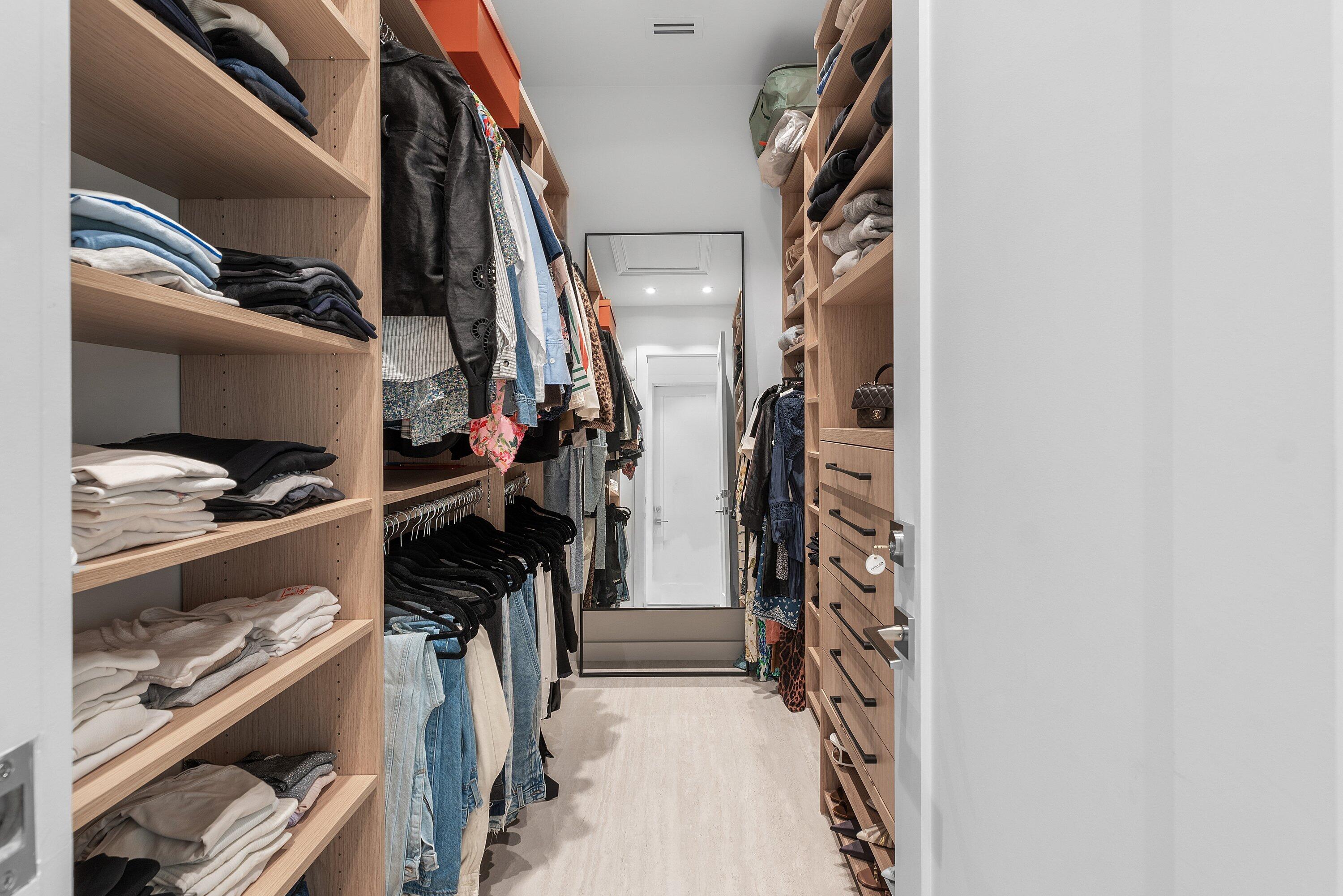 6026 Northwest 31st Way Boca Raton, FL 33496 - Photo 24 of 61 a view of walk in closet with clothes and shoes