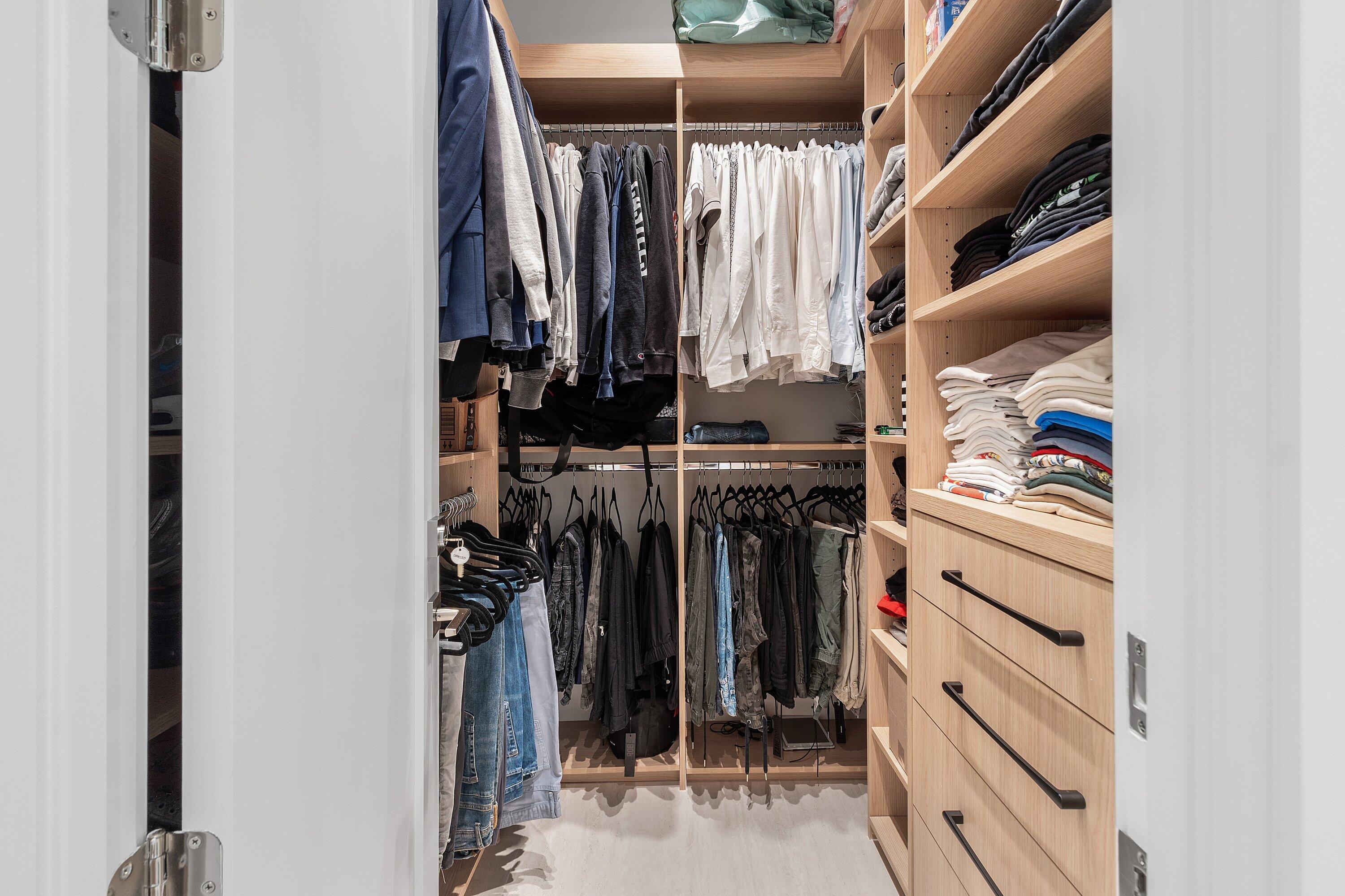 6026 Northwest 31st Way Boca Raton, FL 33496 - Photo 25 of 61 a view of walk in closet with clothes and shoes