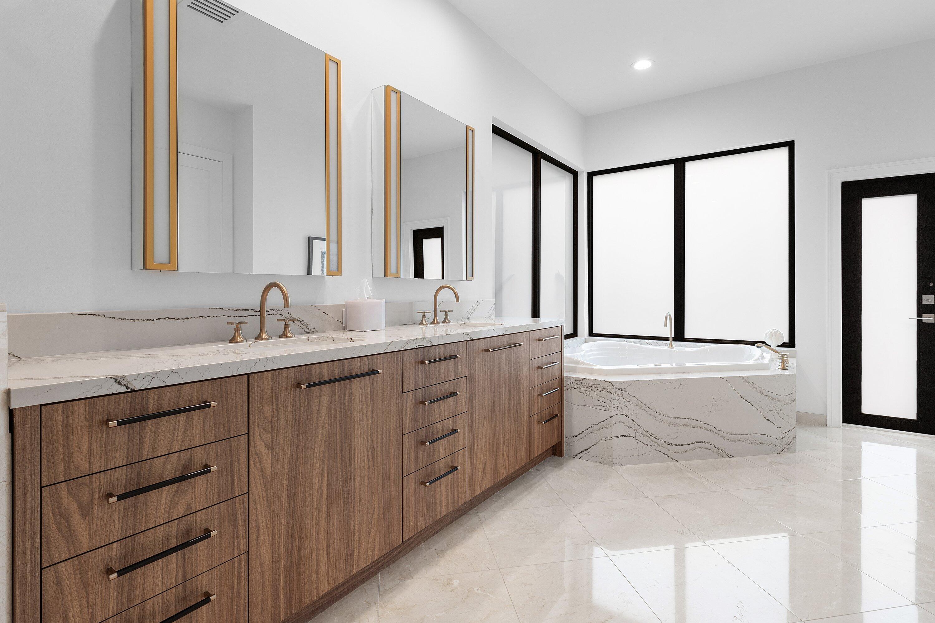 6026 Northwest 31st Way Boca Raton, FL 33496 - Photo 27 of 61 a spacious bathroom with double vanity sink a mirror and a bathtub