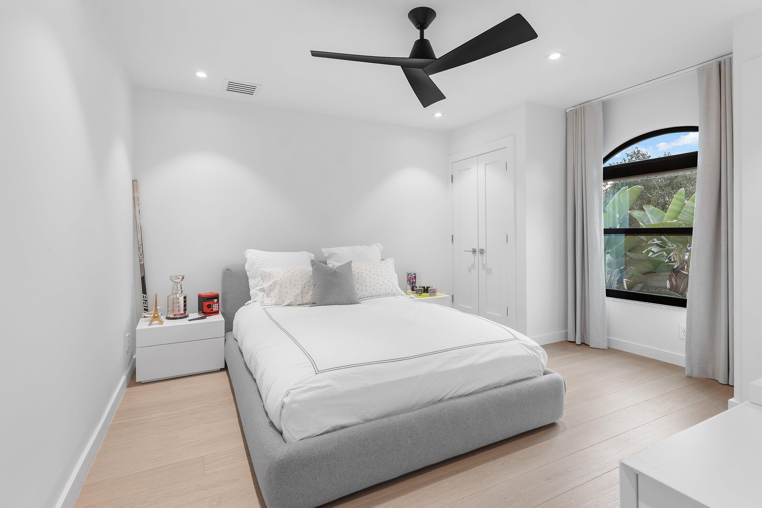 6026 Northwest 31st Way Boca Raton, FL 33496 - Photo 30 of 61 a bedroom with a large bed and a window