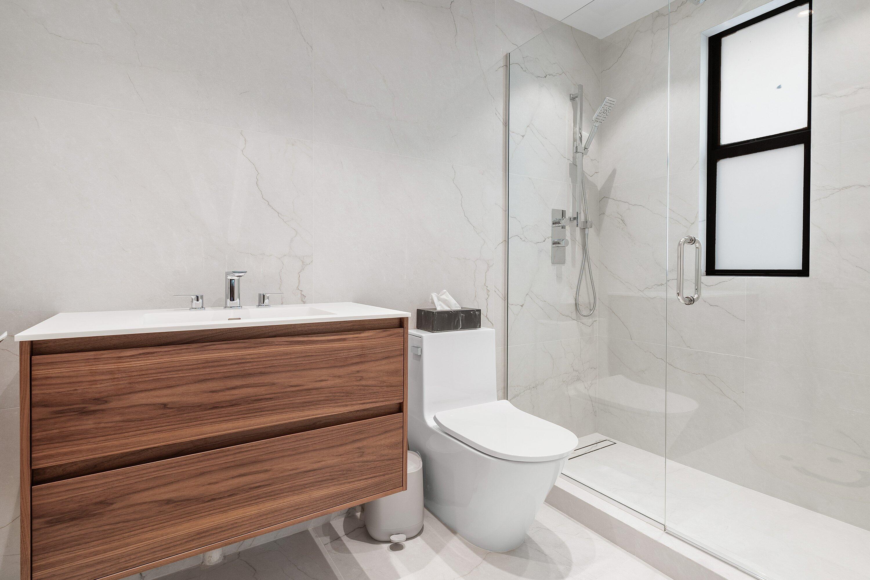 6026 Northwest 31st Way Boca Raton, FL 33496 - Photo 31 of 61 a bathroom with a sink a toilet and shower