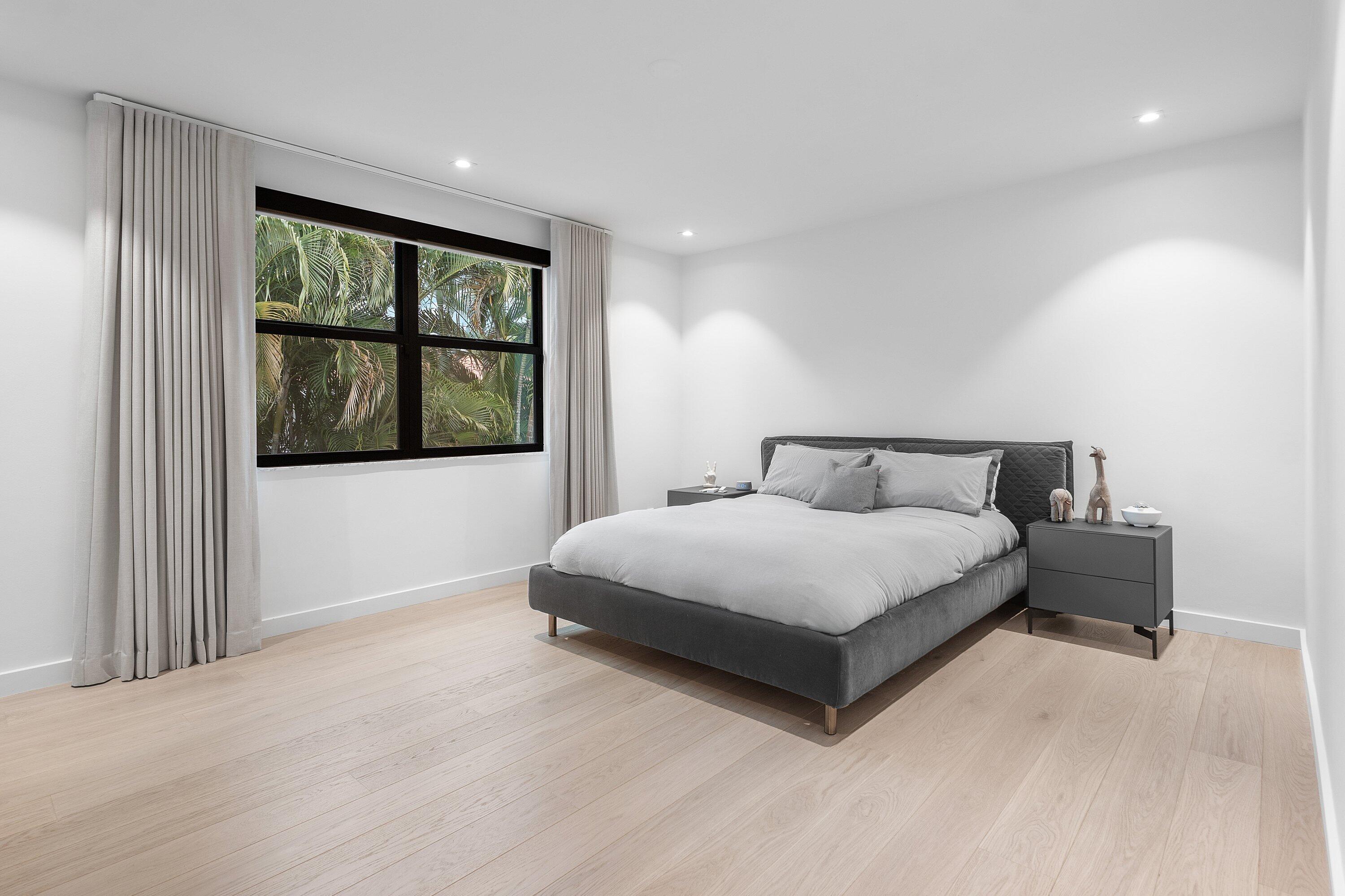 6026 Northwest 31st Way Boca Raton, FL 33496 - Photo 33 of 61 a bedroom with a large bed and a window