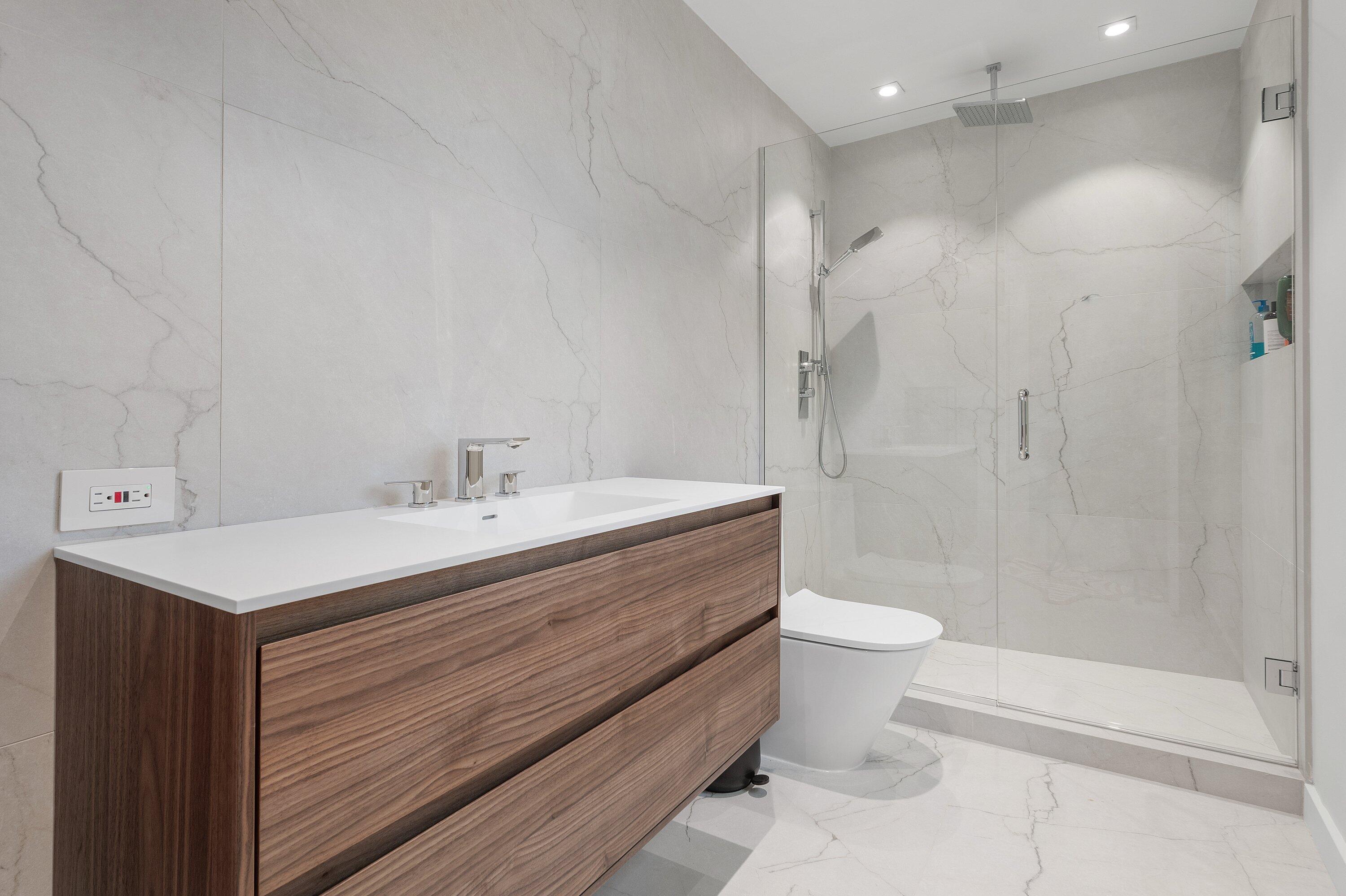 6026 Northwest 31st Way Boca Raton, FL 33496 - Photo 34 of 61 a bathroom with a sink a toilet and shower