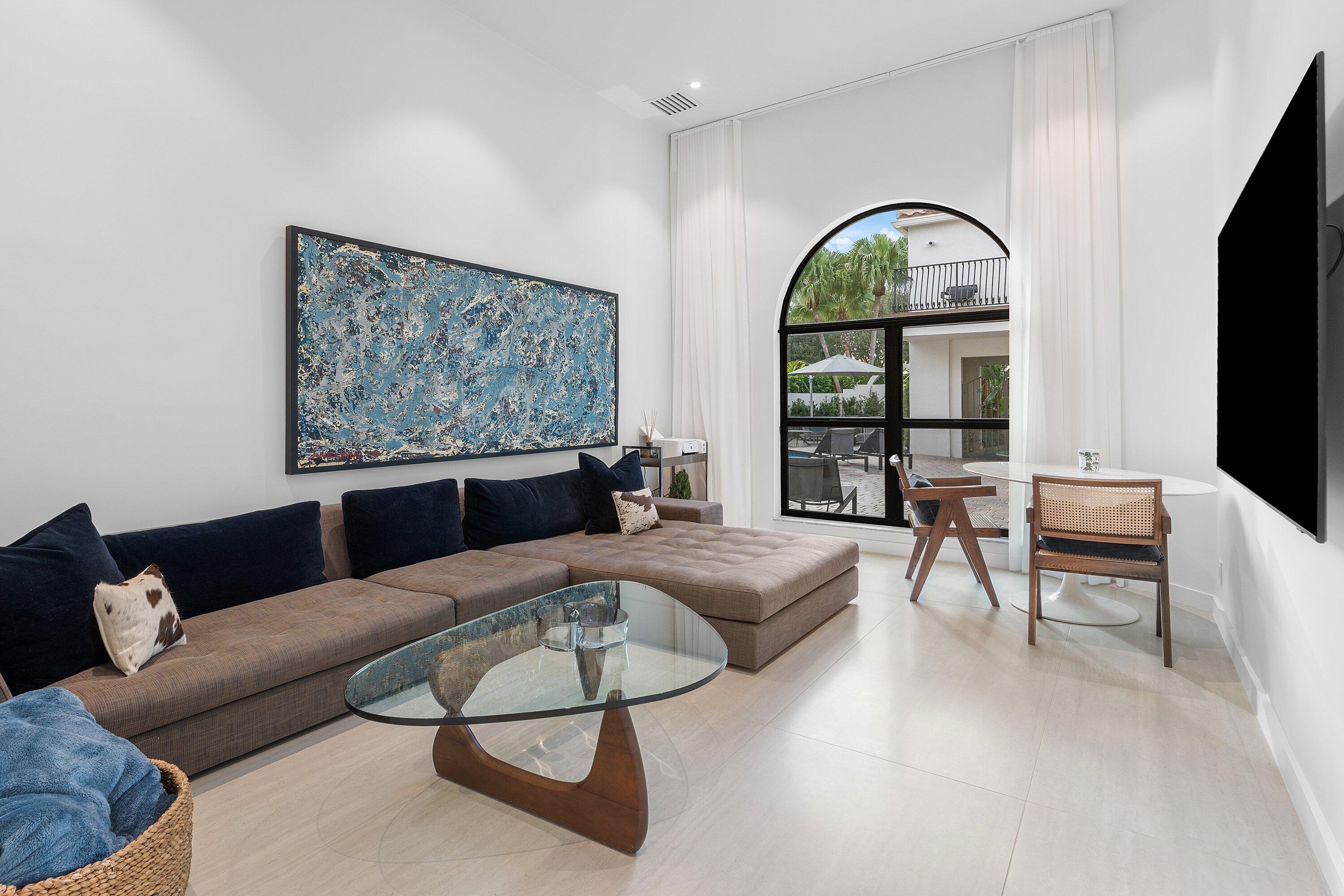 6026 Northwest 31st Way Boca Raton, FL 33496 - Photo 36 of 61 a living room with furniture a large window and potted plants