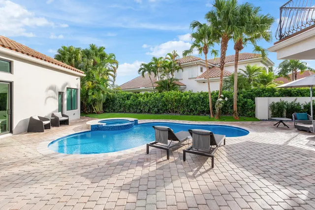 a aerial view of a house with swimming pool and patio