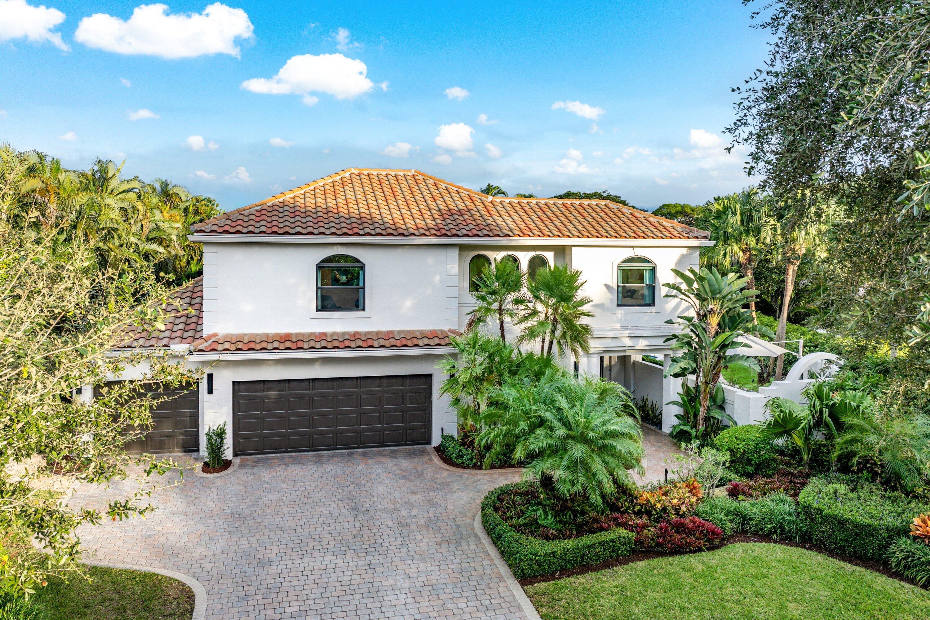 6026 Northwest 31st Way Boca Raton, FL 33496 - Photo 49 of 61 a front view of a house with a garden