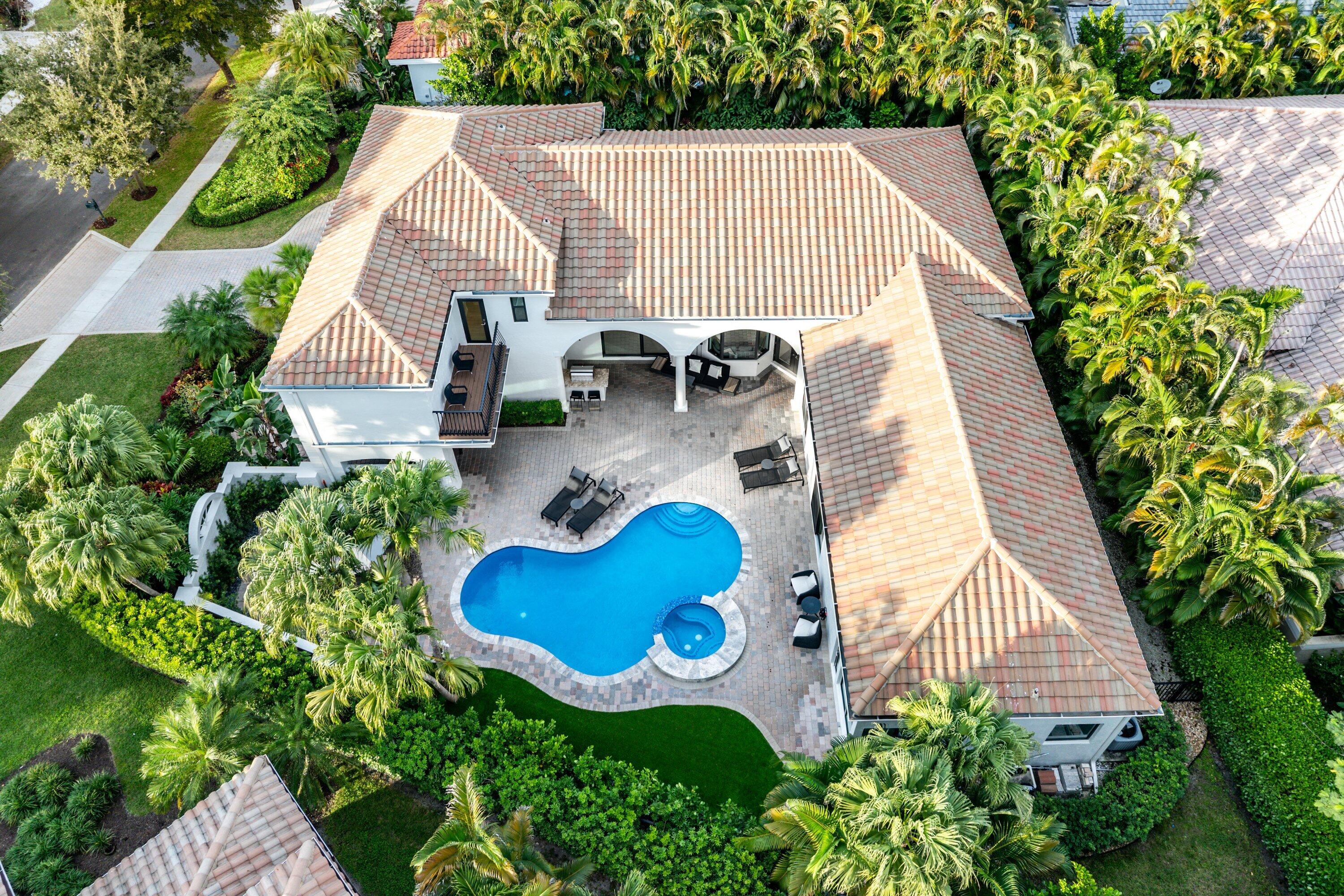 6026 Northwest 31st Way Boca Raton, FL 33496 - Photo 53 of 61 a aerial view of a house with swimming pool and patio
