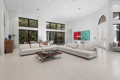 a living room with furniture and large window