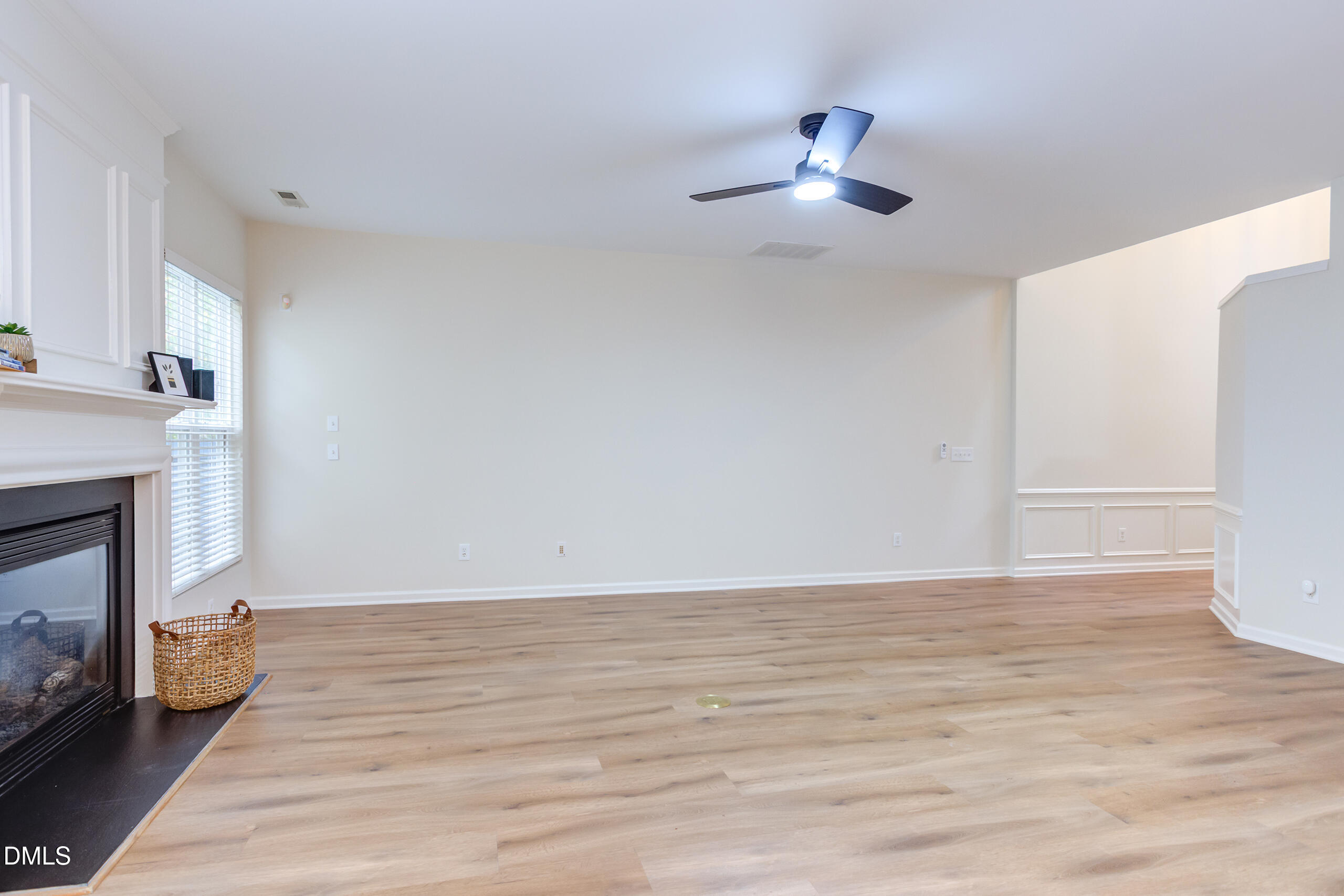 5620 Berry Creek Circle Raleigh, NC 27613 - Photo 11 of 38 a view of an empty room with wooden floor and a fireplace
