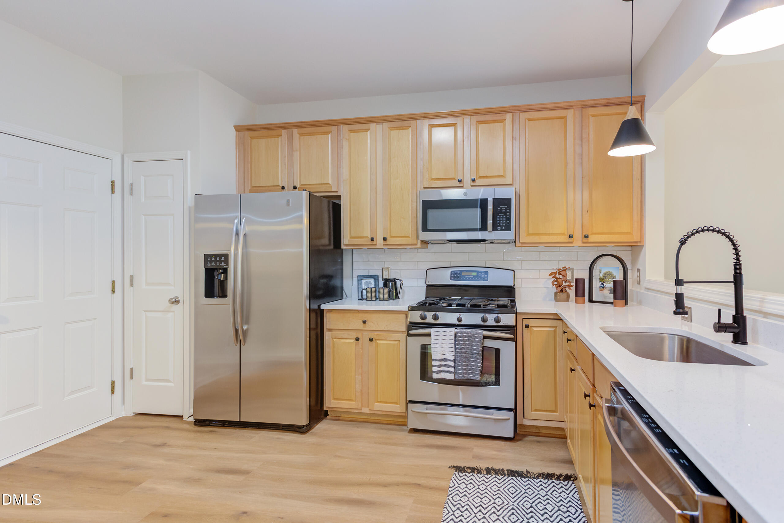 5620 Berry Creek Circle Raleigh, NC 27613 - Photo 13 of 38 a kitchen with stainless steel appliances granite countertop a refrigerator stove and sink