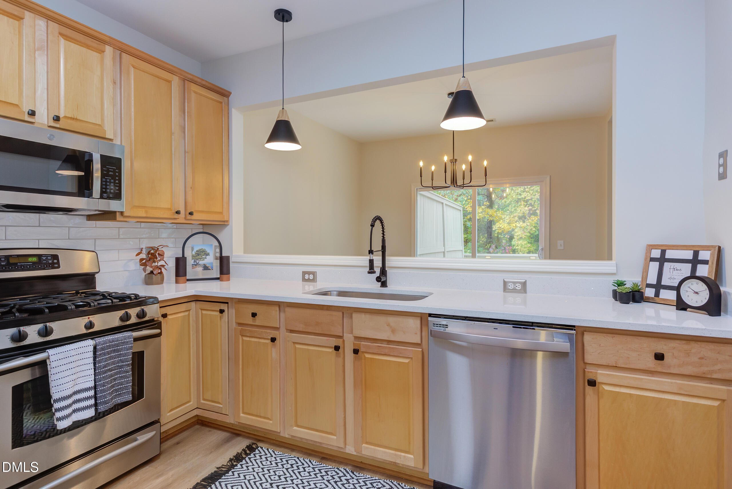 5620 Berry Creek Circle Raleigh, NC 27613 - Photo 16 of 38 a kitchen with a sink stove and cabinets