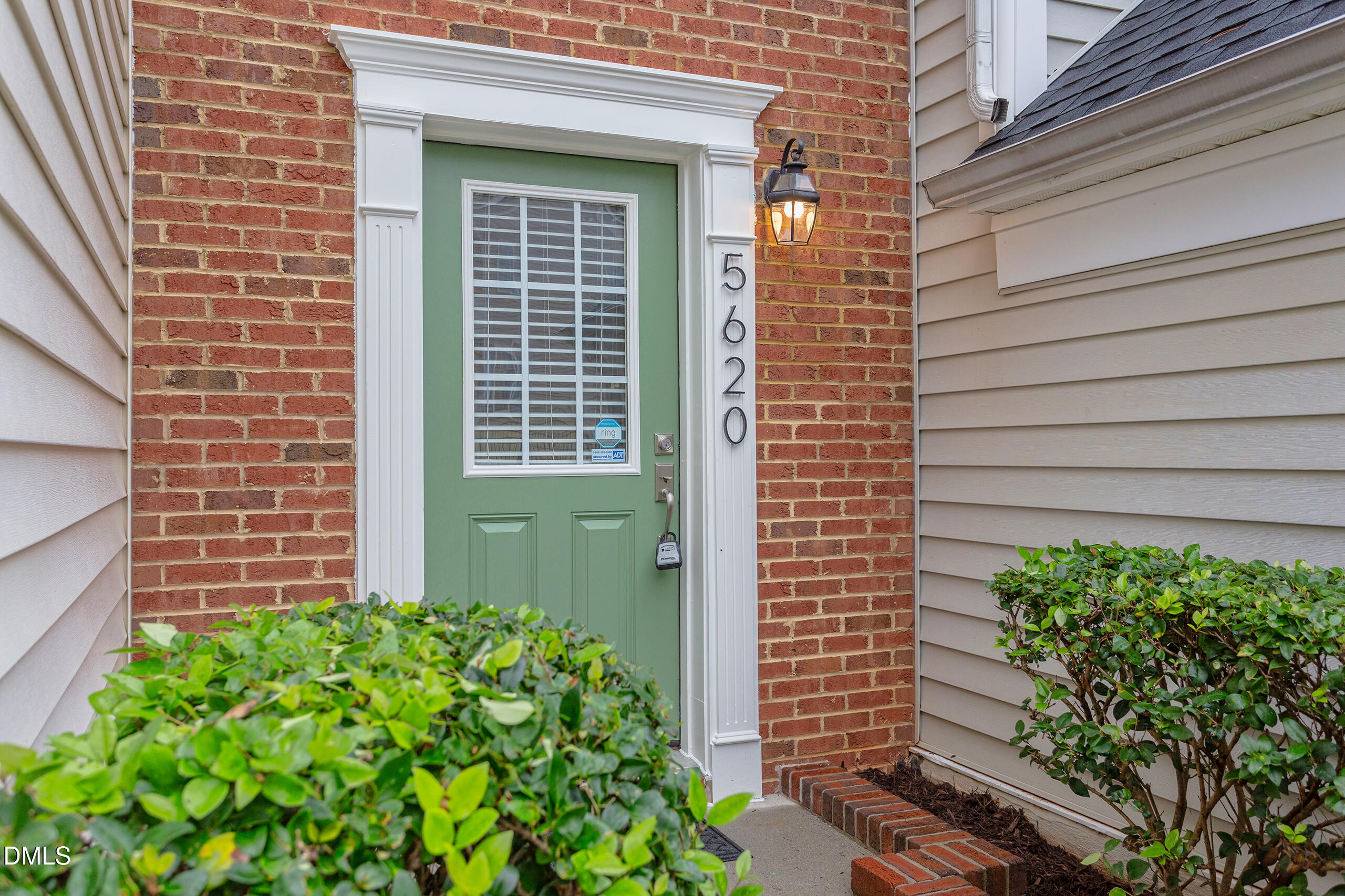 5620 Berry Creek Circle Raleigh, NC 27613 - Photo 2 of 38 a view of a brick house with a flower garden