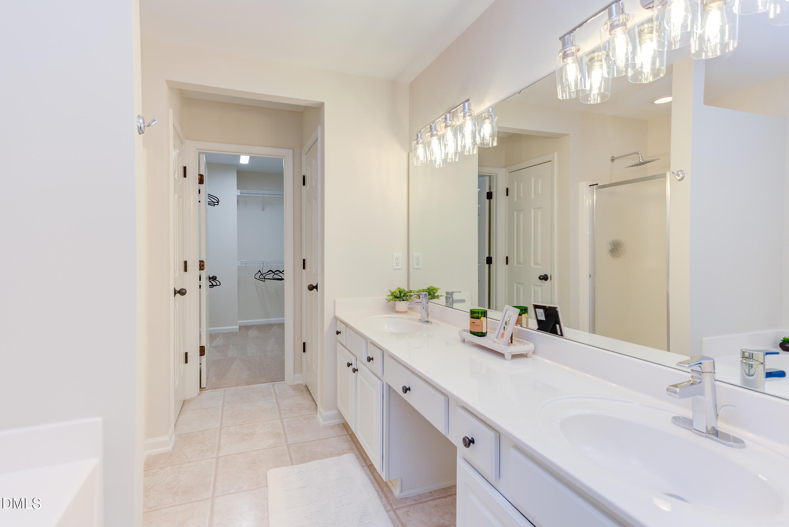 5620 Berry Creek Circle Raleigh, NC 27613 - Photo 21 of 38 a spacious bathroom with double vanity sinks a large mirror and a shower
