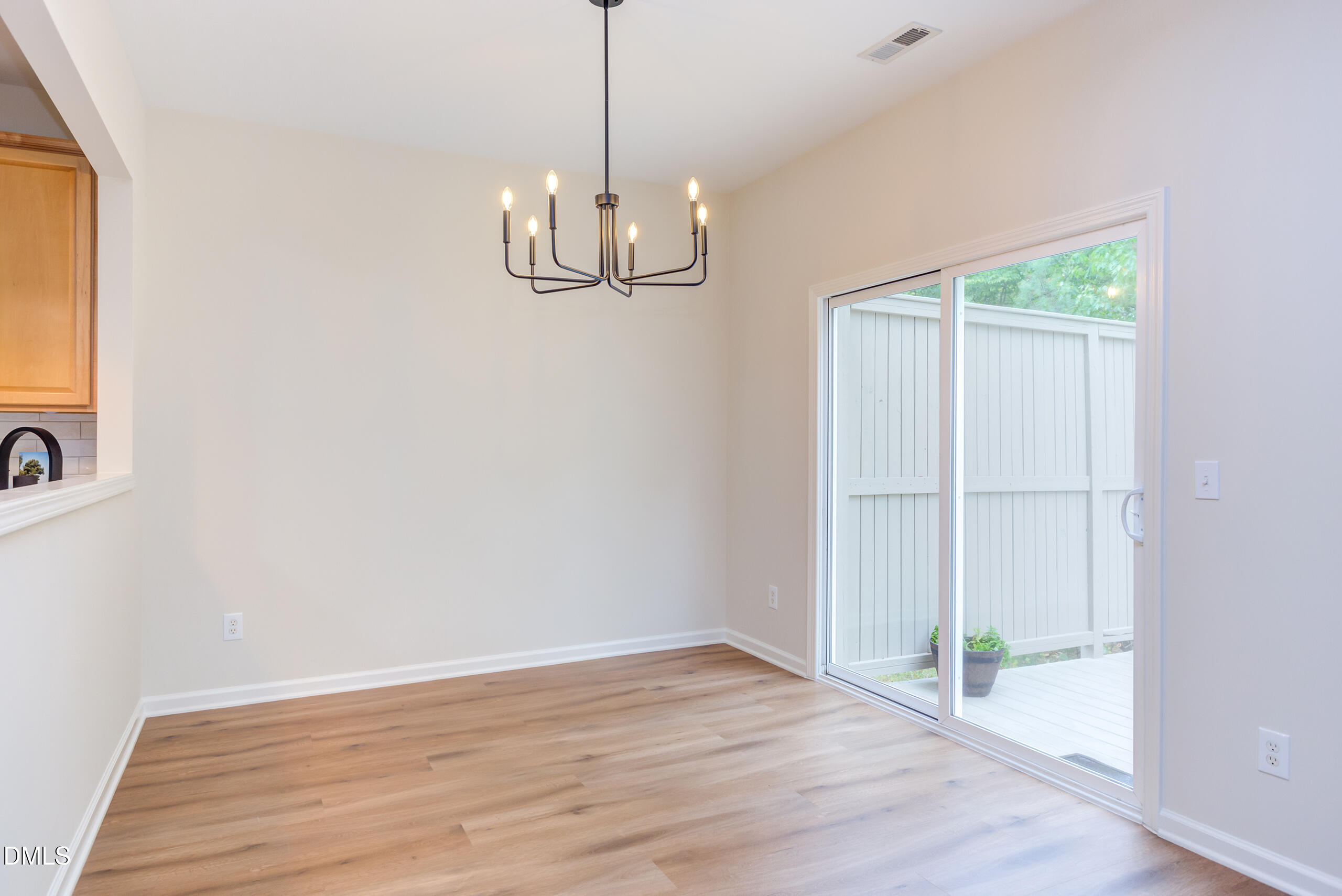 5620 Berry Creek Circle Raleigh, NC 27613 - Photo 9 of 38 a view of empty room with wooden floor and fan