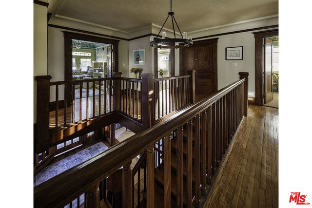 a bedroom with a bed chair and a large window